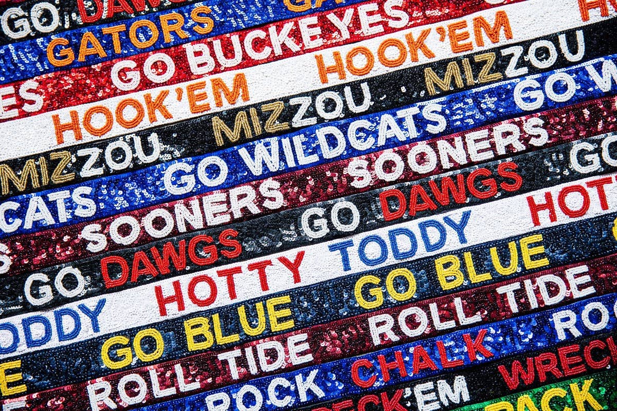 Collection of colorful woven text bands with sports team names.