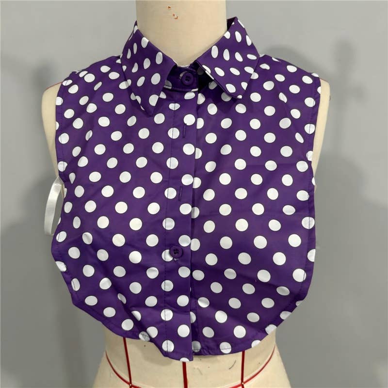 Purple shirt with white polka dots on a mannequin against a gray background