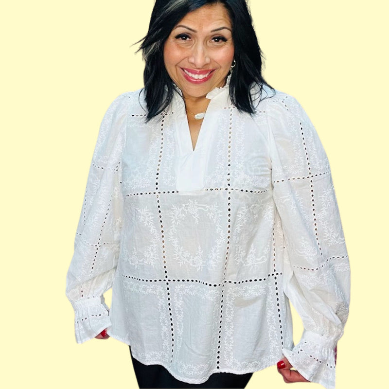 Woman wearing a white lace blouse against a yellow background