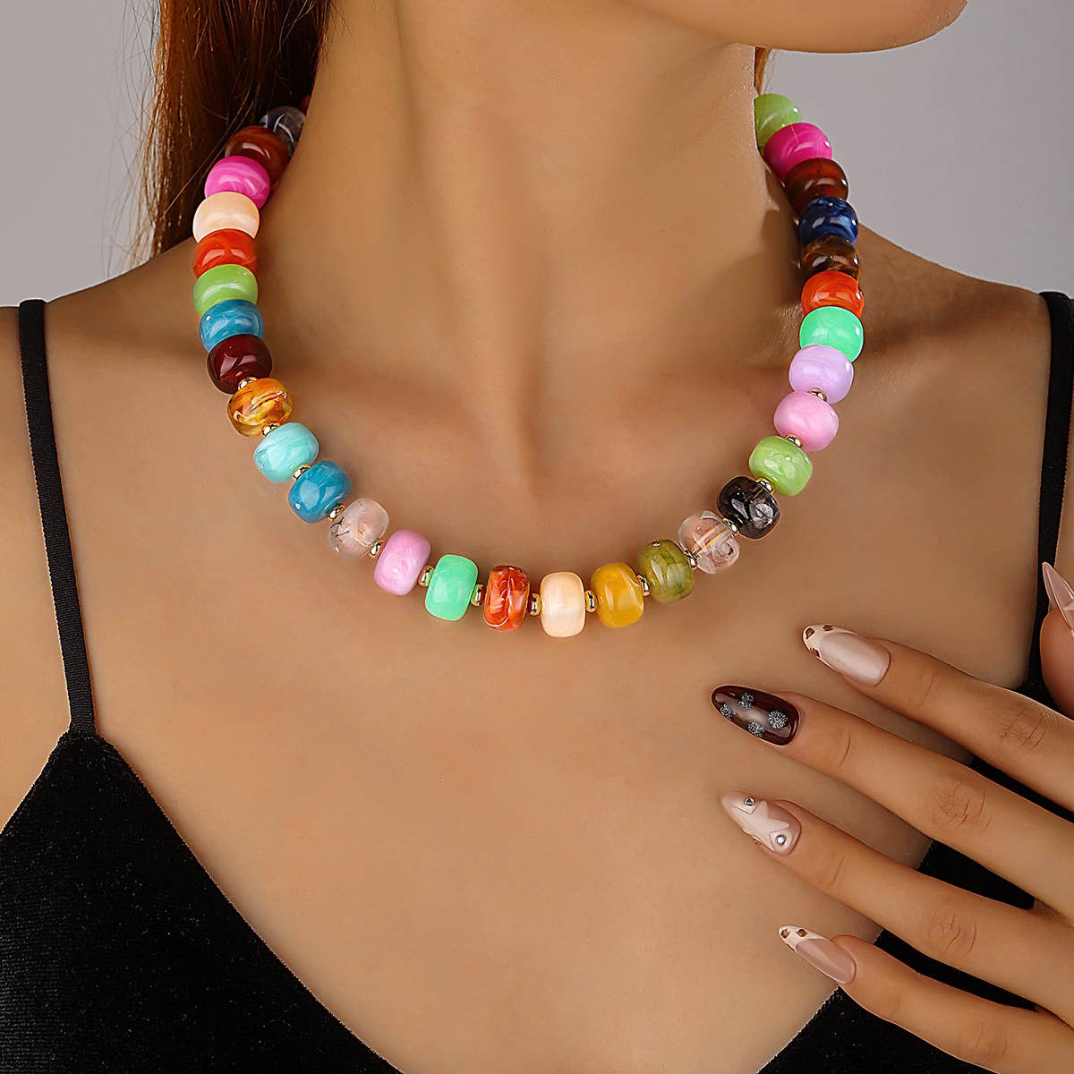 Colorful beaded necklace on a model with a neutral background