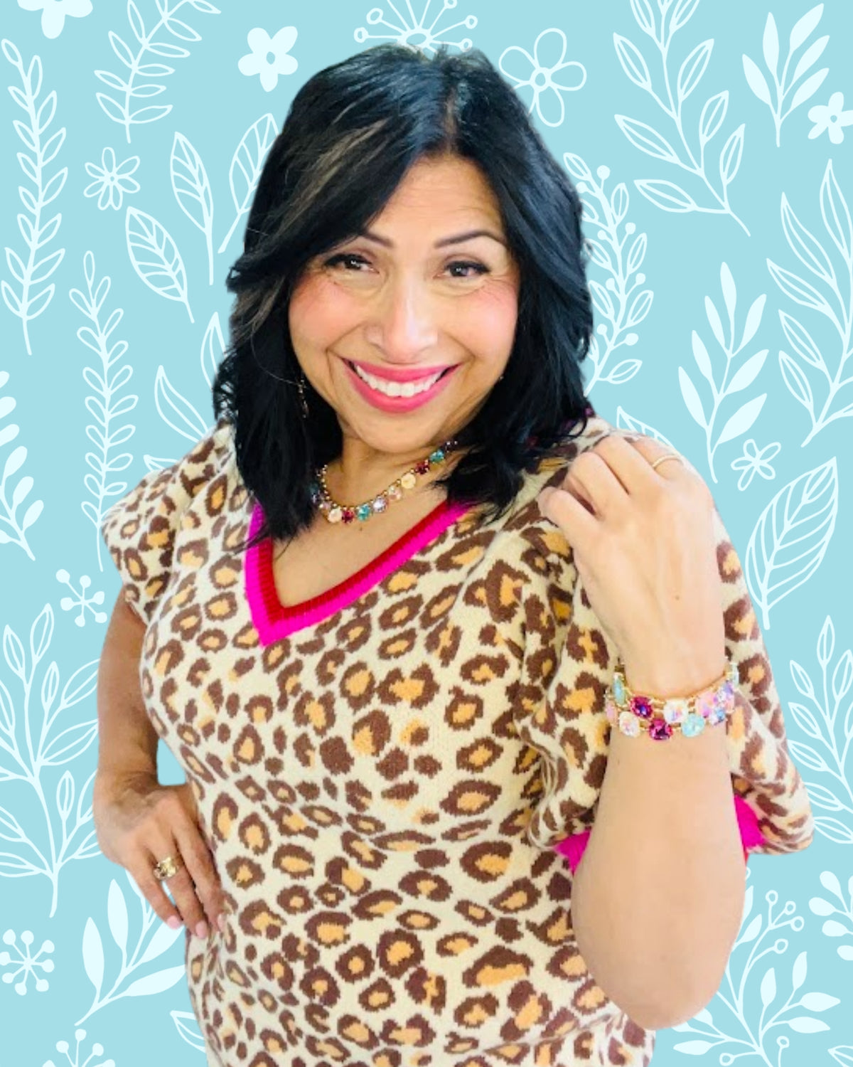Woman wearing a leopard print top with a floral patterned background