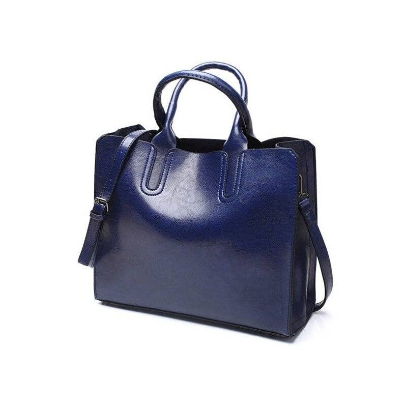 A navy blue leather tote bag with double top handles and a detachable shoulder strap, shown on a plain white background.