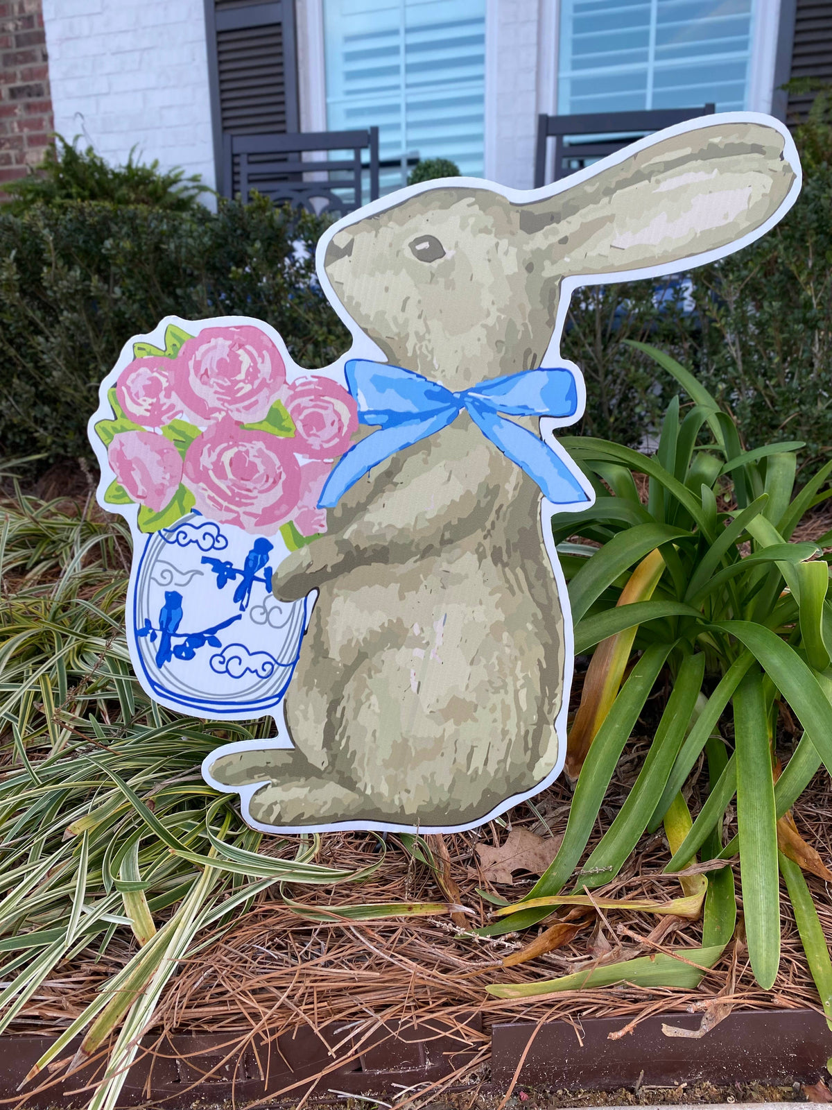 Bunny yard sign holding flowers