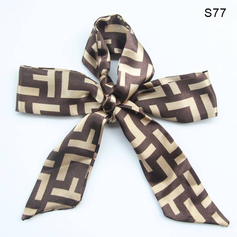 Brown and beige patterned scarf tied into a bow on a white background