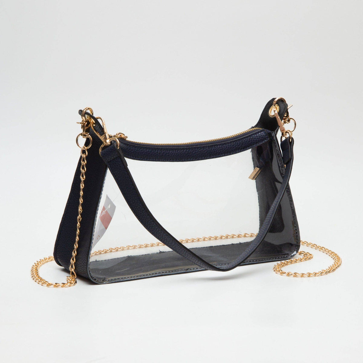 Black handbag with clear front panel and gold chain strap on a white background