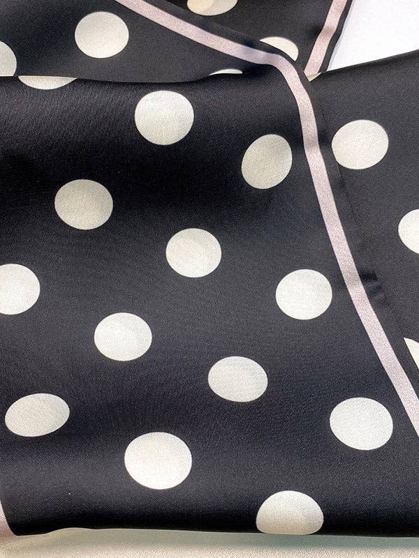 Black fabric with white polka dots and a pink border