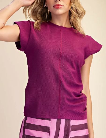 Model wearing a plum colored short sleeve top
