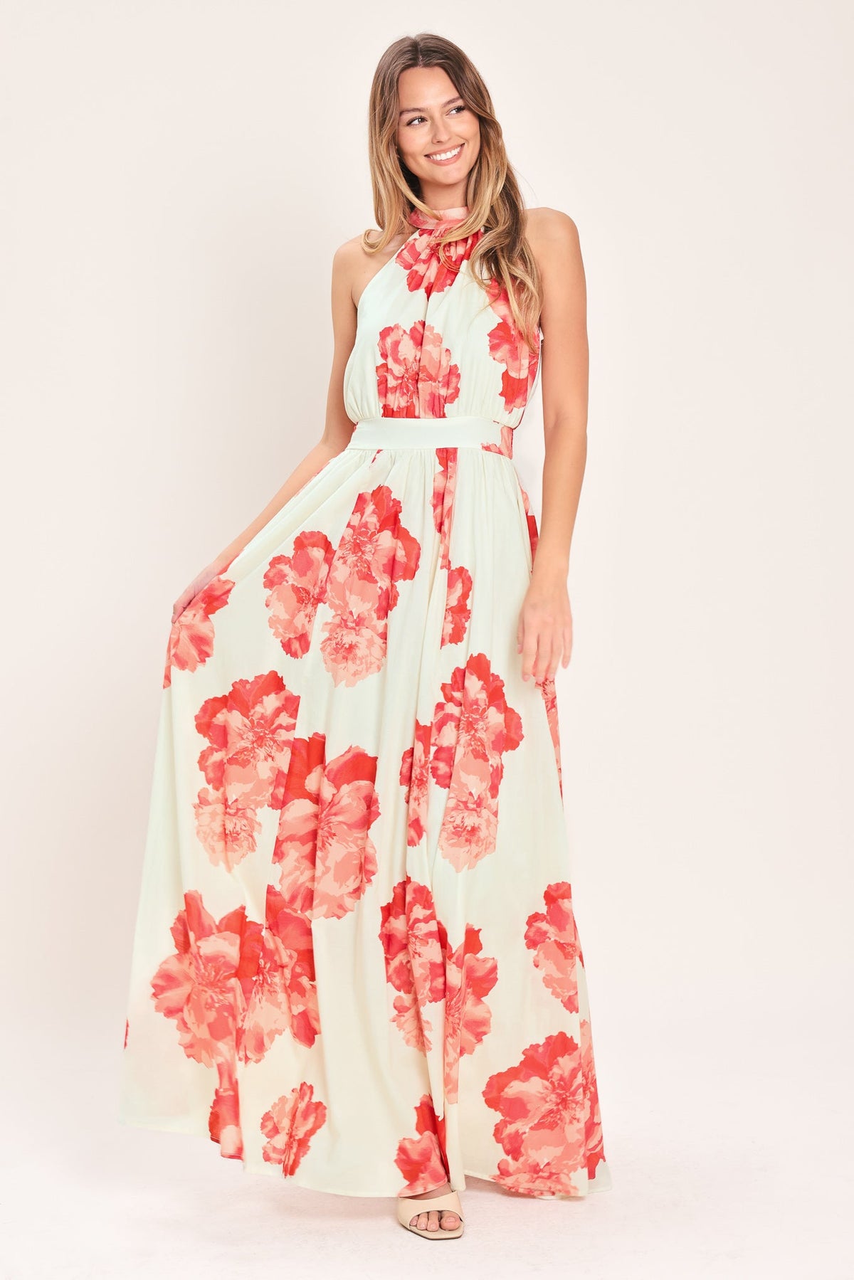 Woman wearing a floral dress with red flowers on a white background