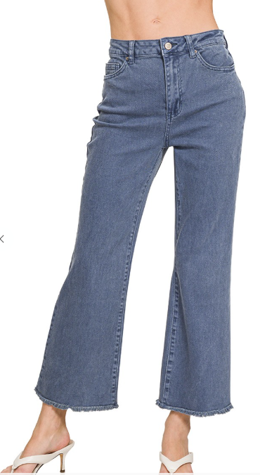 Blue jeans worn by a person on a white background