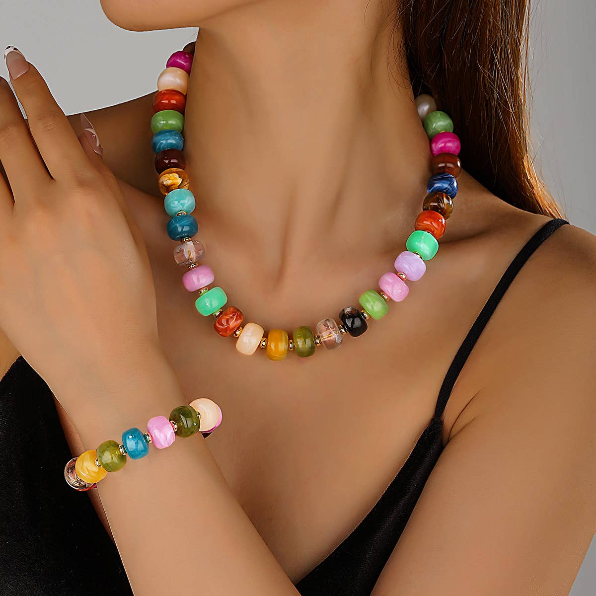 Colorful beaded necklace worn by a person against a neutral background
