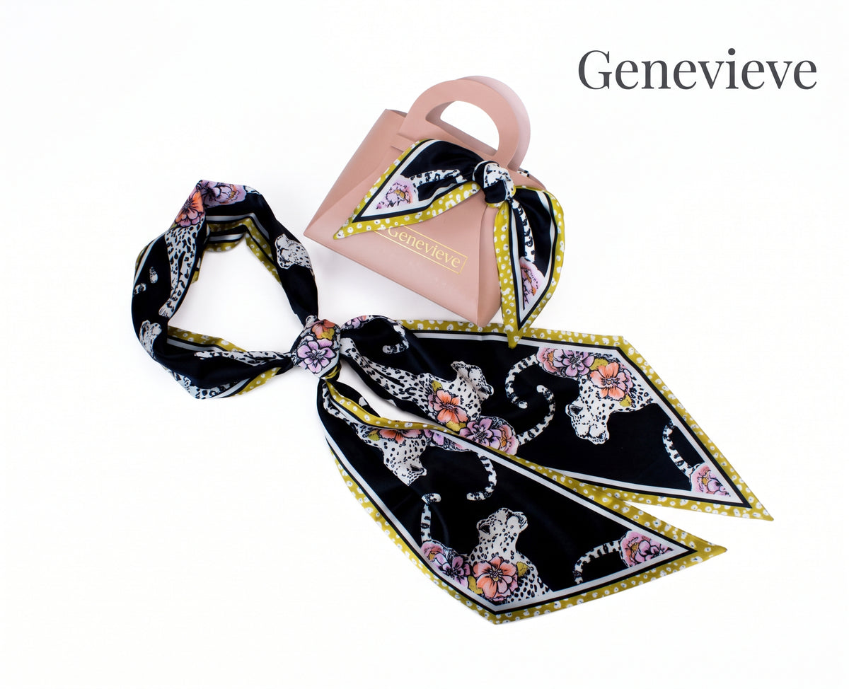 A black silk scarf with a leopard and floral print, styled next to a light pink handbag with the brand name Genevieve, on a white background with the brand name text in the upper right.