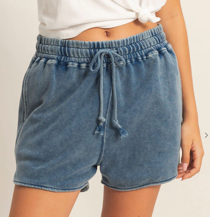 Blue denim shorts with drawstring waist on a plain background