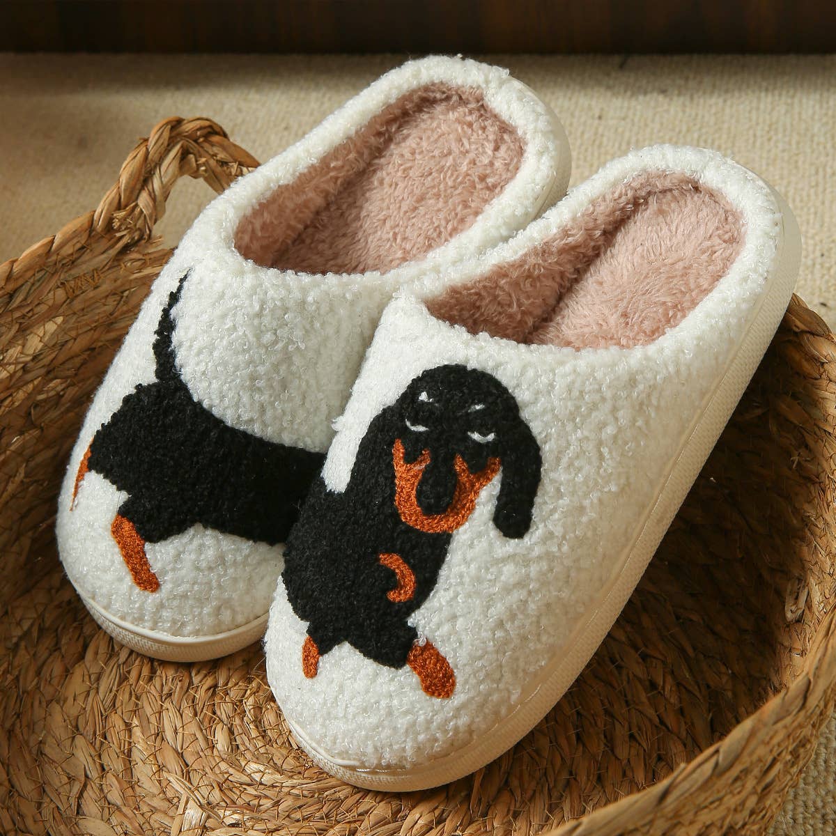 White slippers with dachshund design on a woven mat
