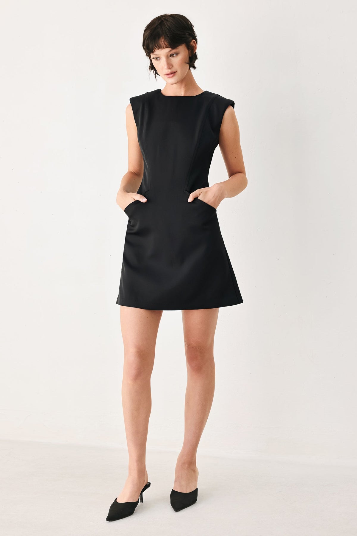 Woman wearing a black dress on a white background