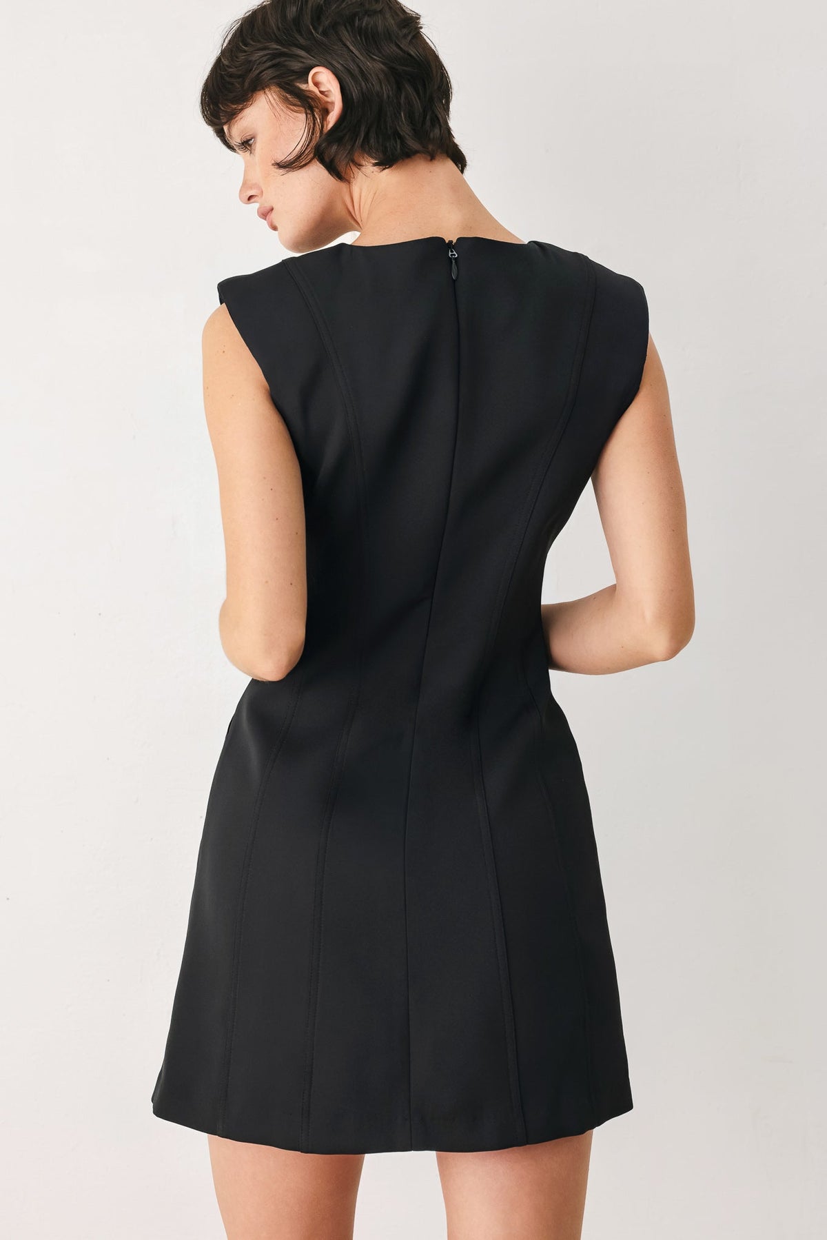 Black dress worn by a person on a white background