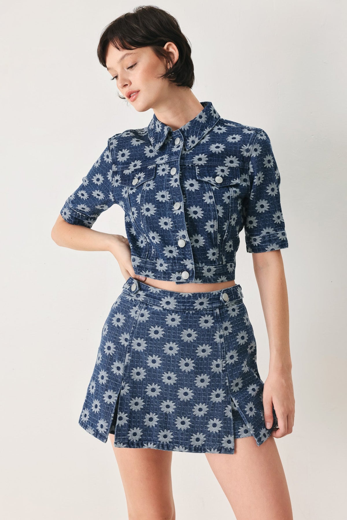 Woman wearing a blue floral dress on a white background