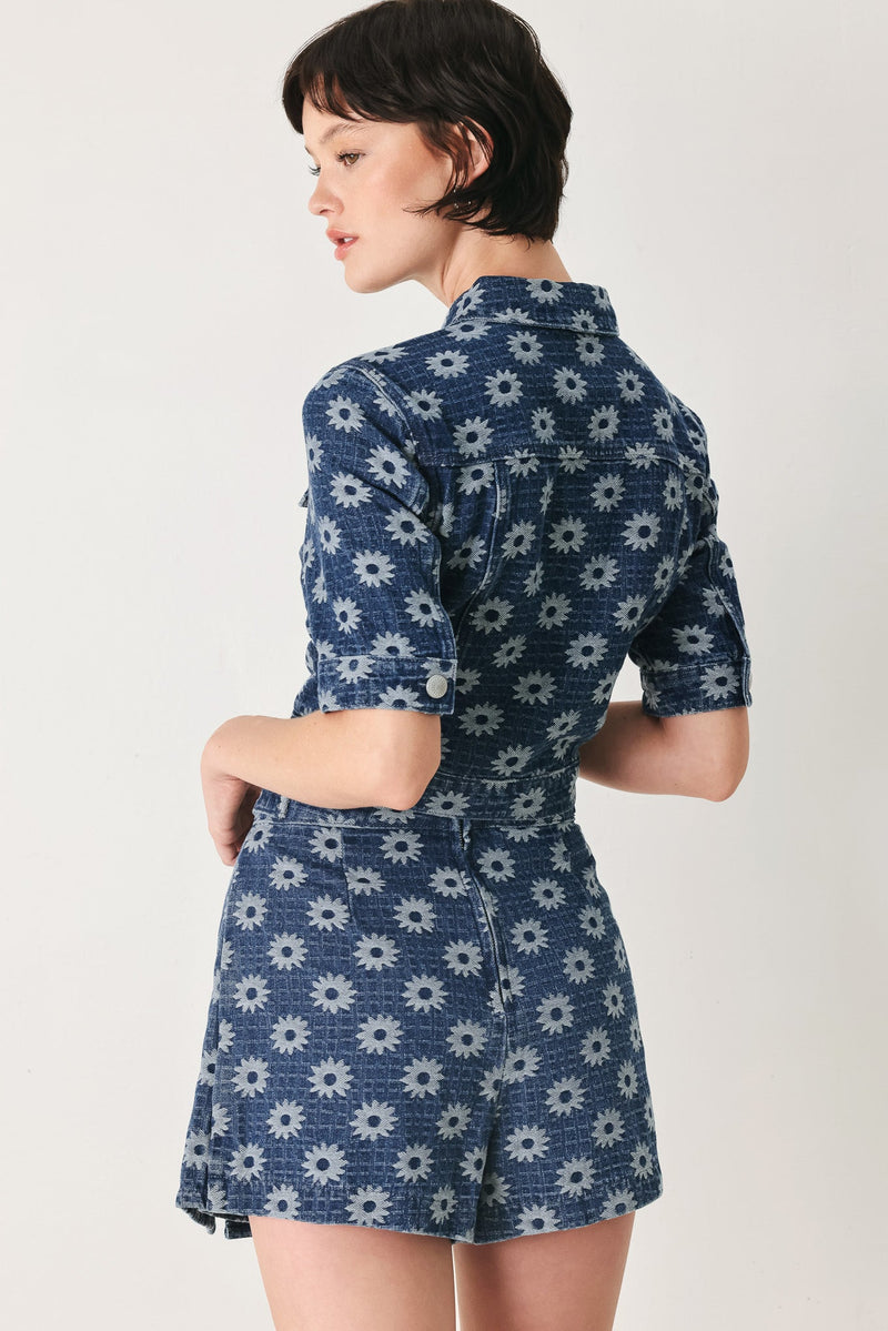 Woman wearing a blue floral dress on a white background