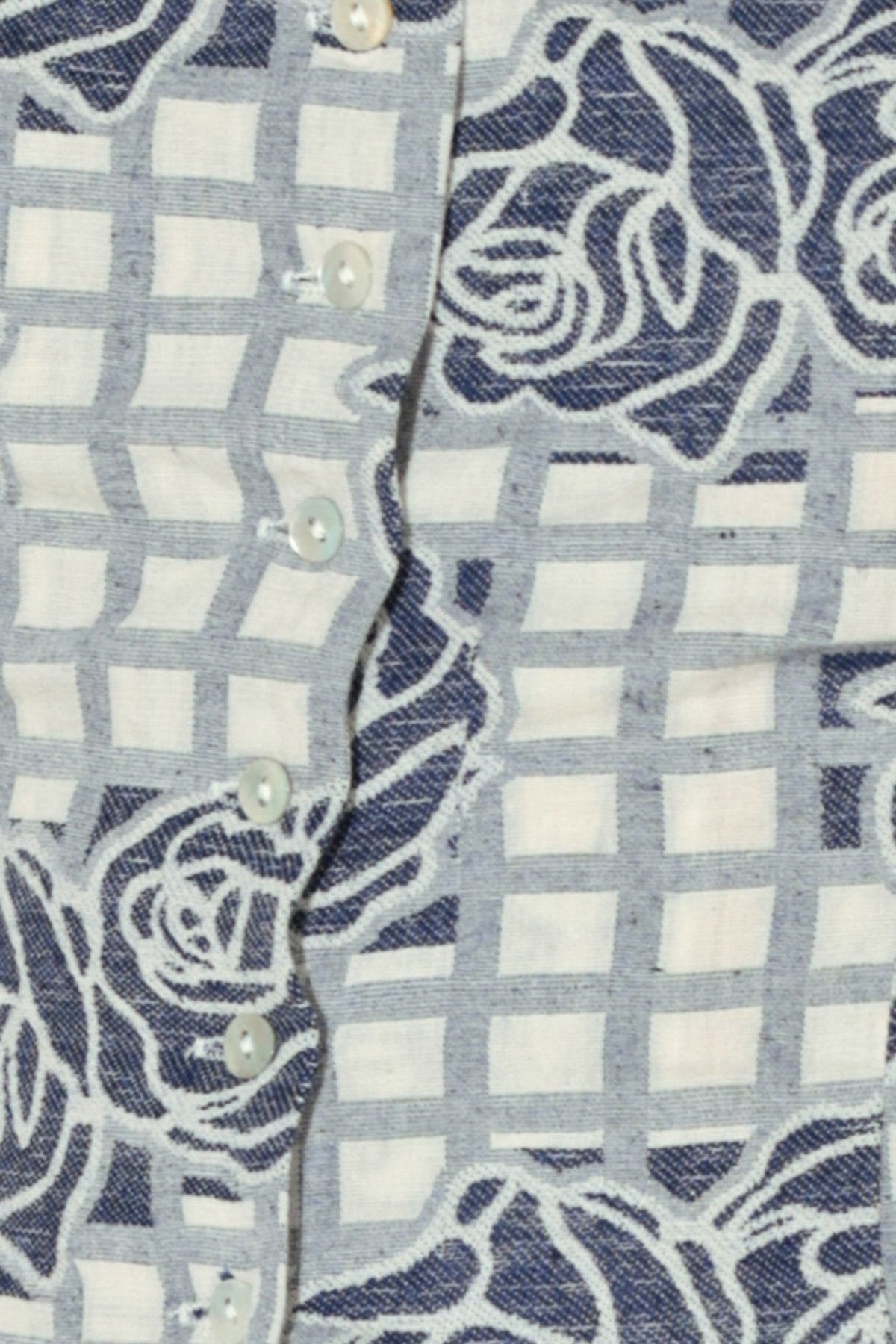 Close-up of a shirt with blue floral and checkered pattern