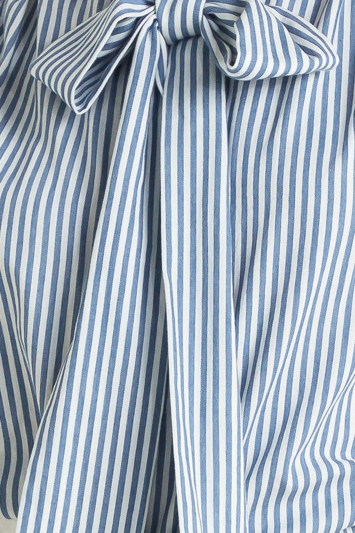 Close-up of a blue and white striped garment with a bow detail.