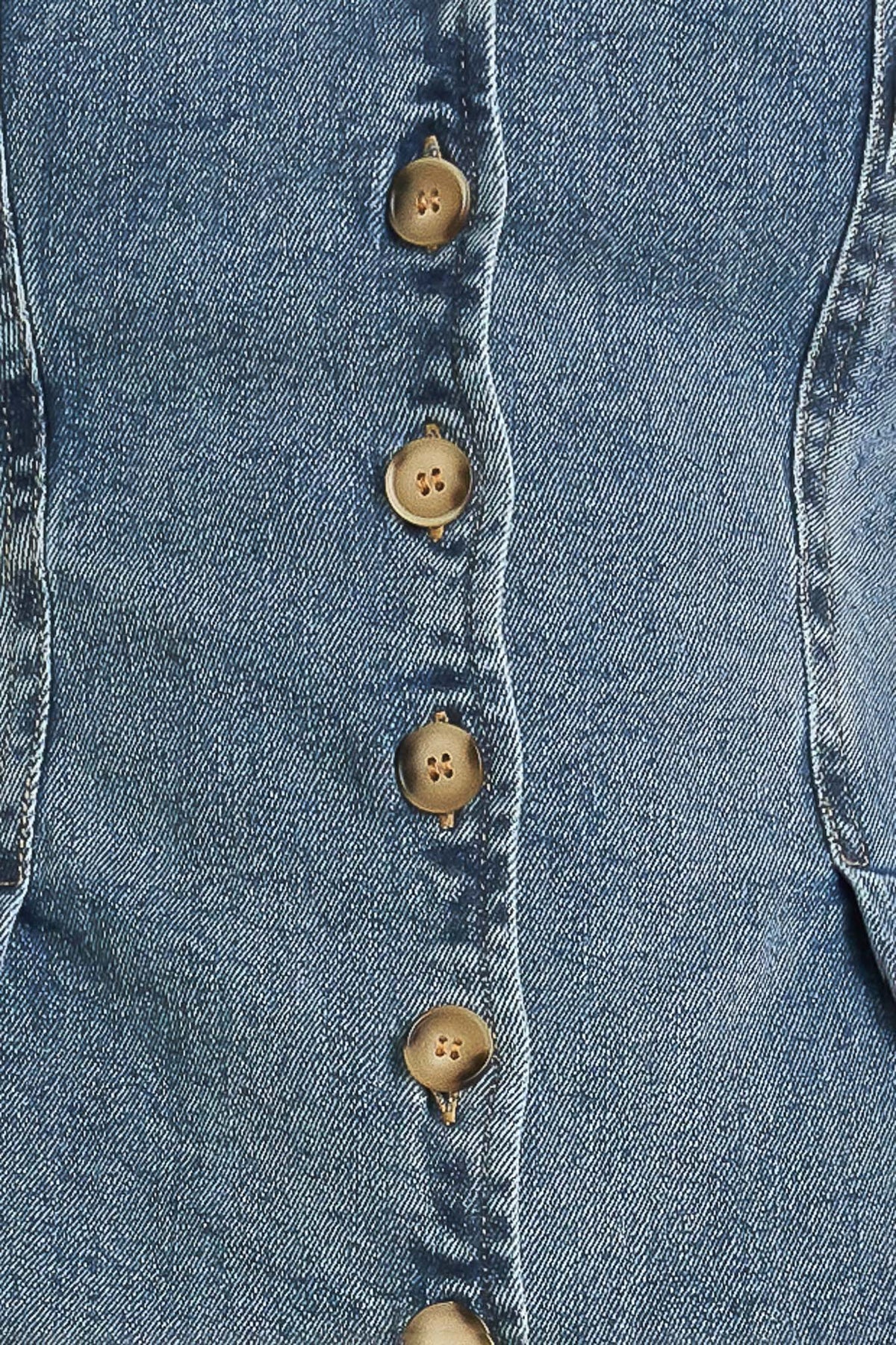 Close-up of a denim vest with button details