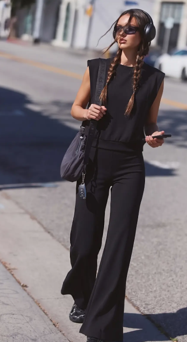 Model wearing a matching black travel set
