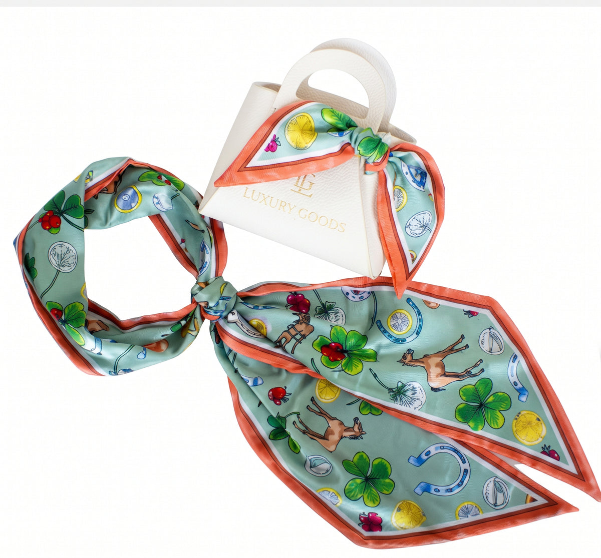 A square silk scarf with a light green background and a colorful equestrian-themed print featuring horses, clovers, horseshoes, and luck symbols, styled with a white handbag that has the brand name 'LUXURY GOODS' printed on it, set against a plain white background.