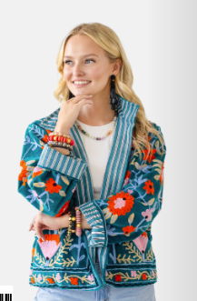woman wearing printed reversible jacket in teal