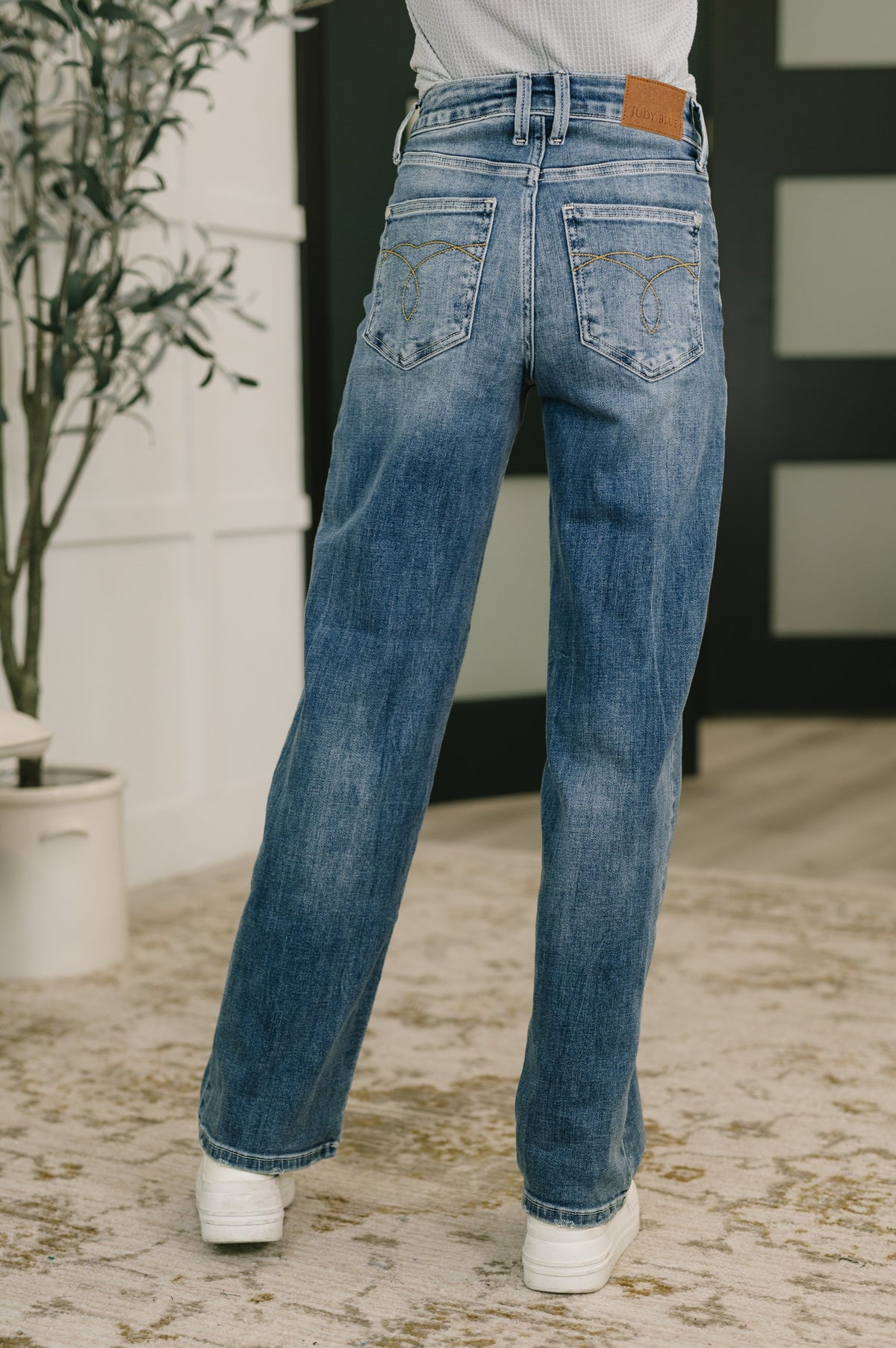 Person wearing blue jeans with a blurred background