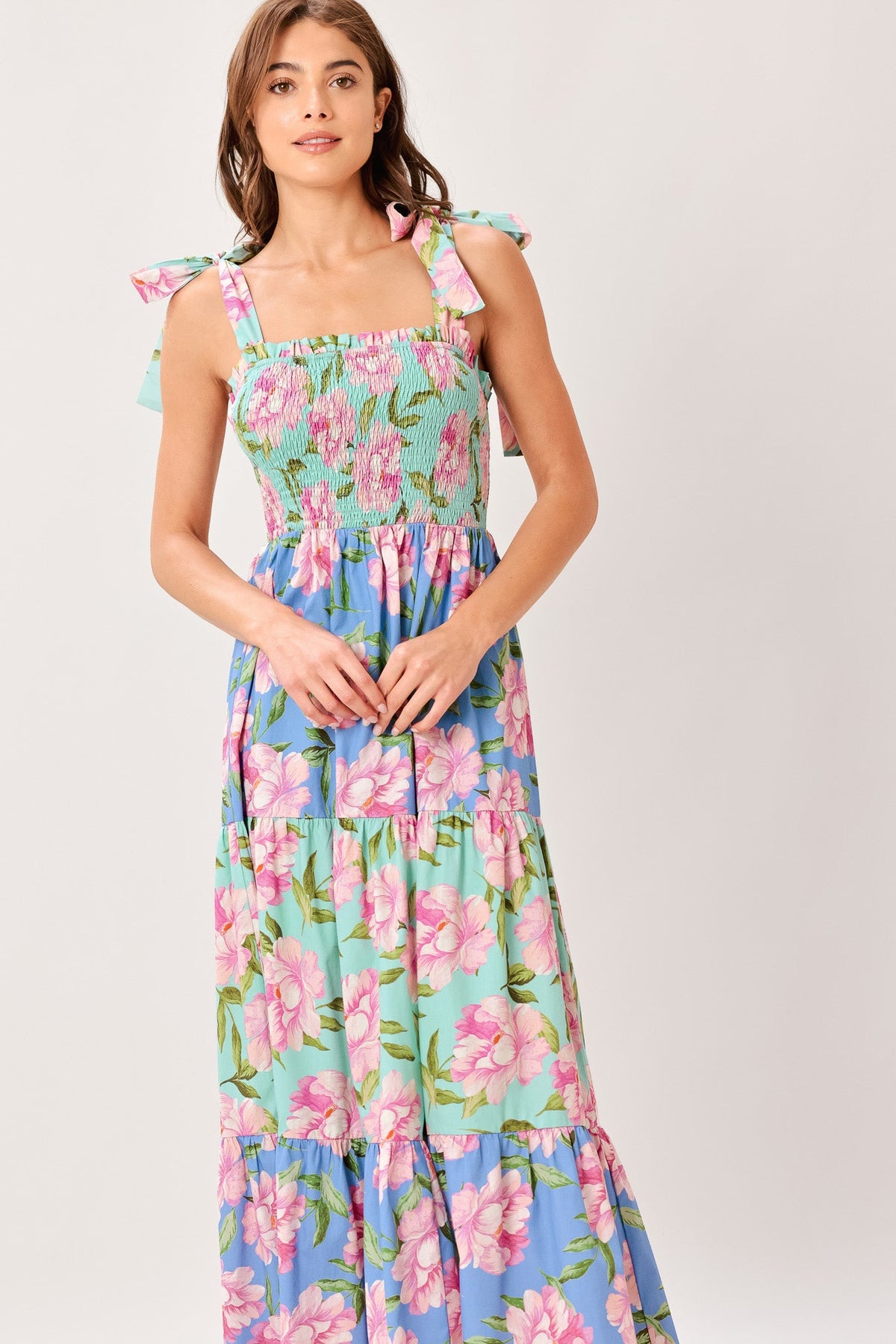 Woman wearing a floral dress with a white background