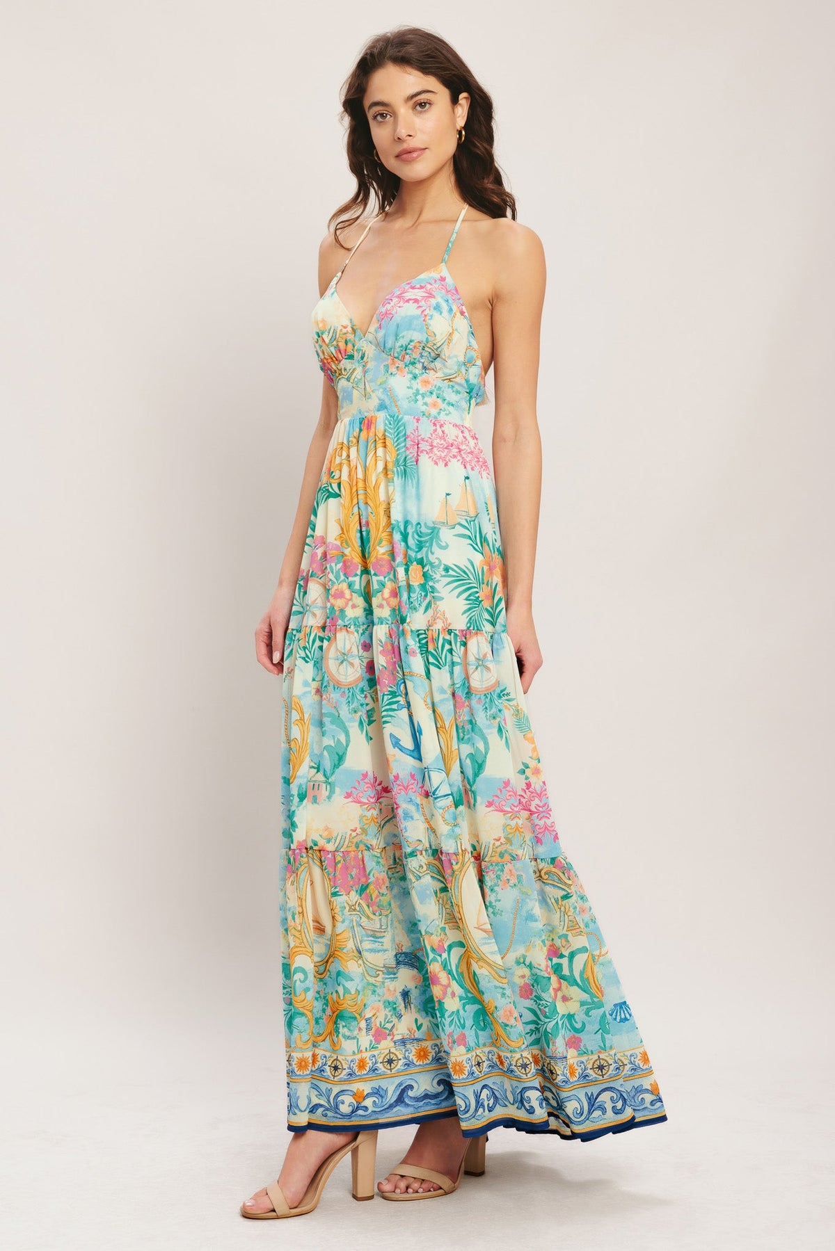 Woman wearing a colorful floral dress on a white background