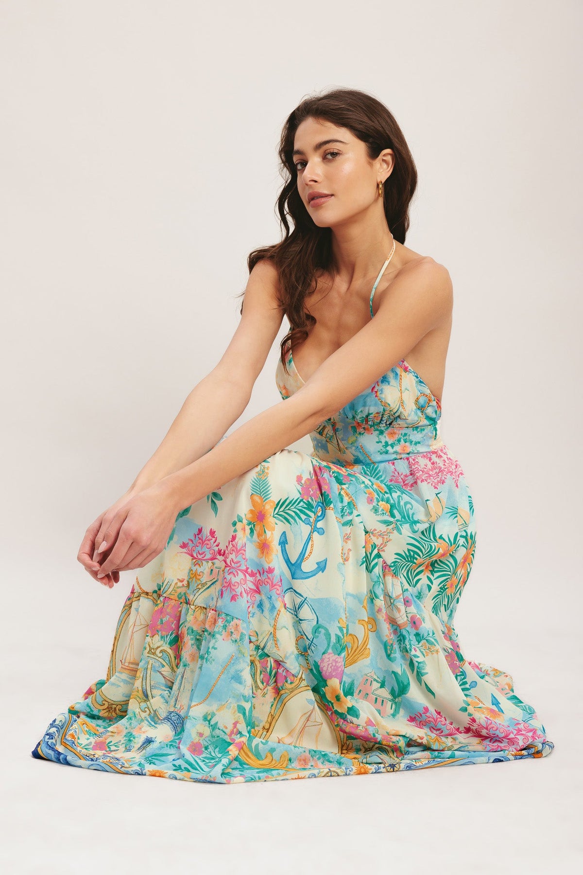 Woman wearing a colorful floral dress on a white background
