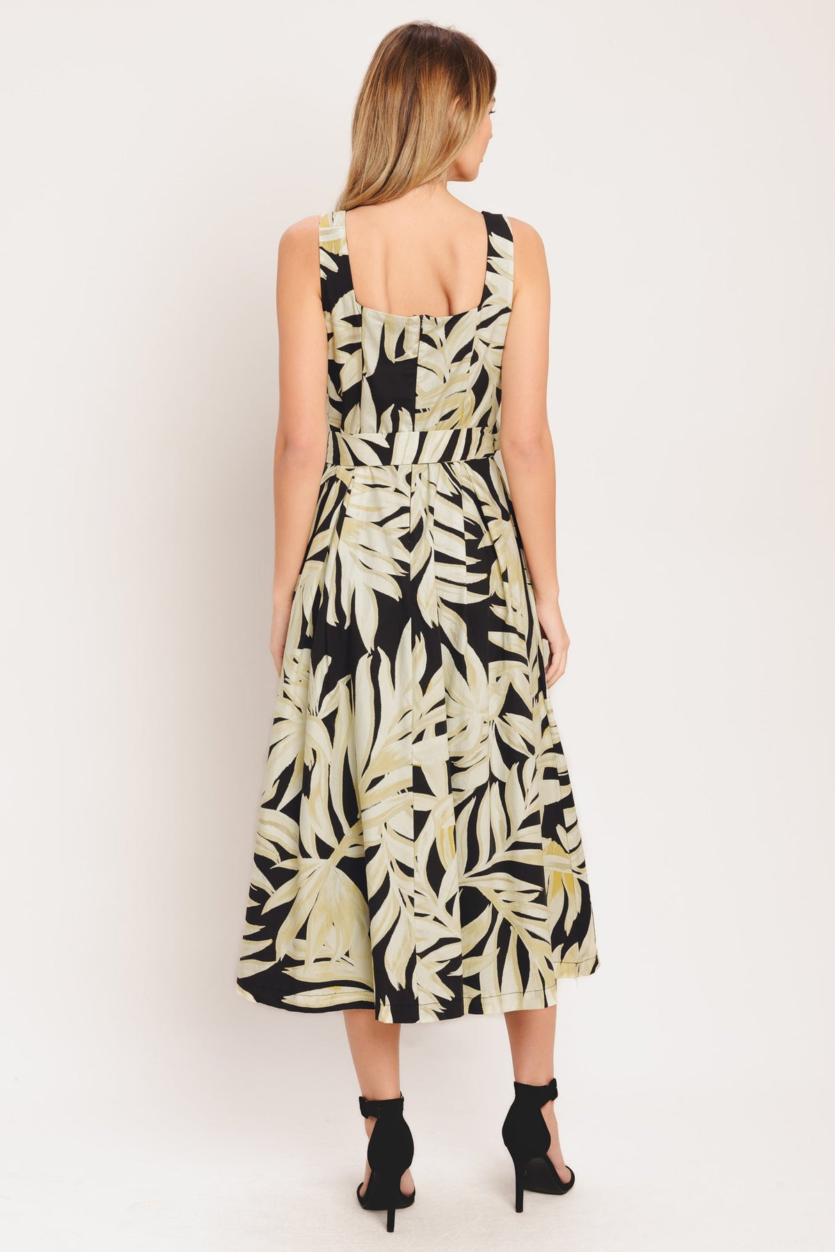 woman wearing leaf printed dress