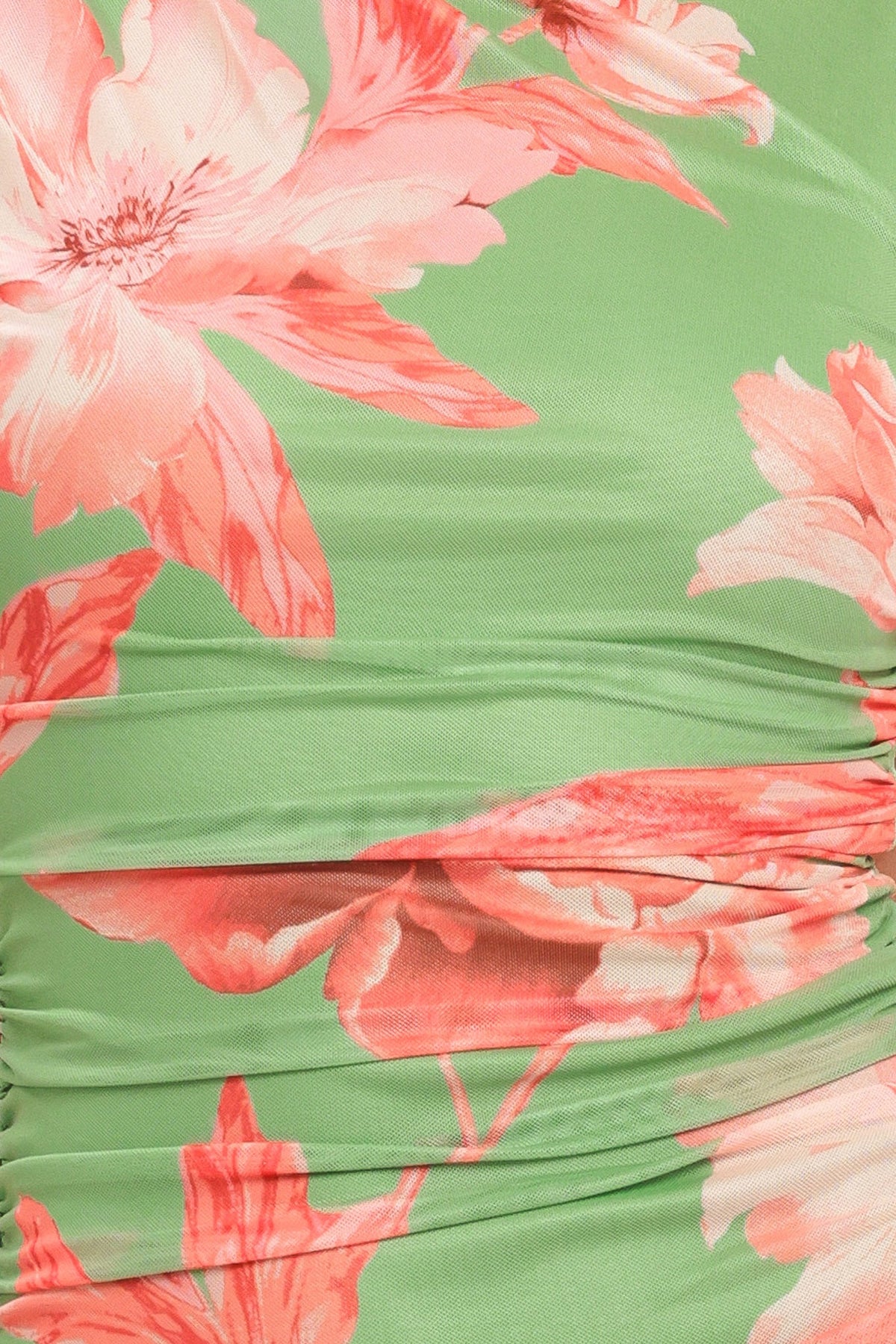 Close-up of a green fabric with pink floral patterns