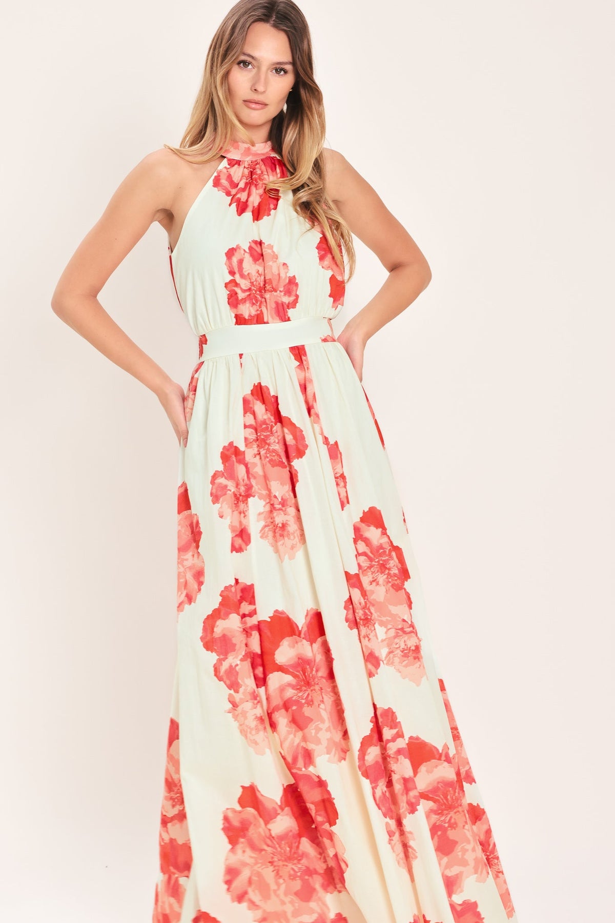 Woman wearing a floral dress with a plain background