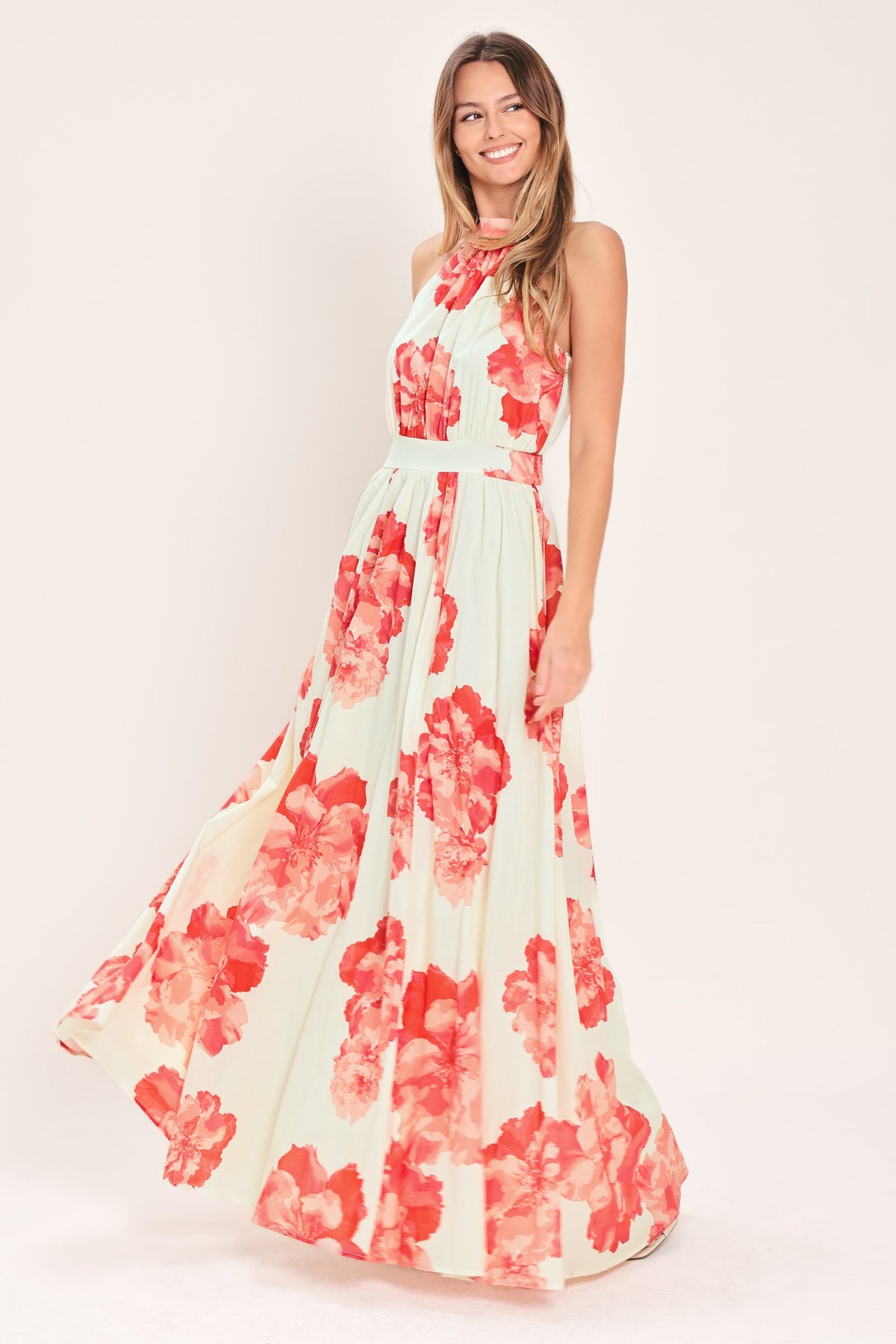 Woman wearing a floral dress with red flowers on a white background