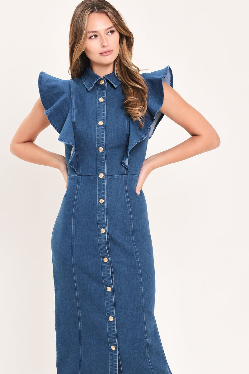 A woman modeling a blue denim midi dress with ruffled cap sleeves, a pointed collar, and a front button closure, set against a plain light beige studio background.
