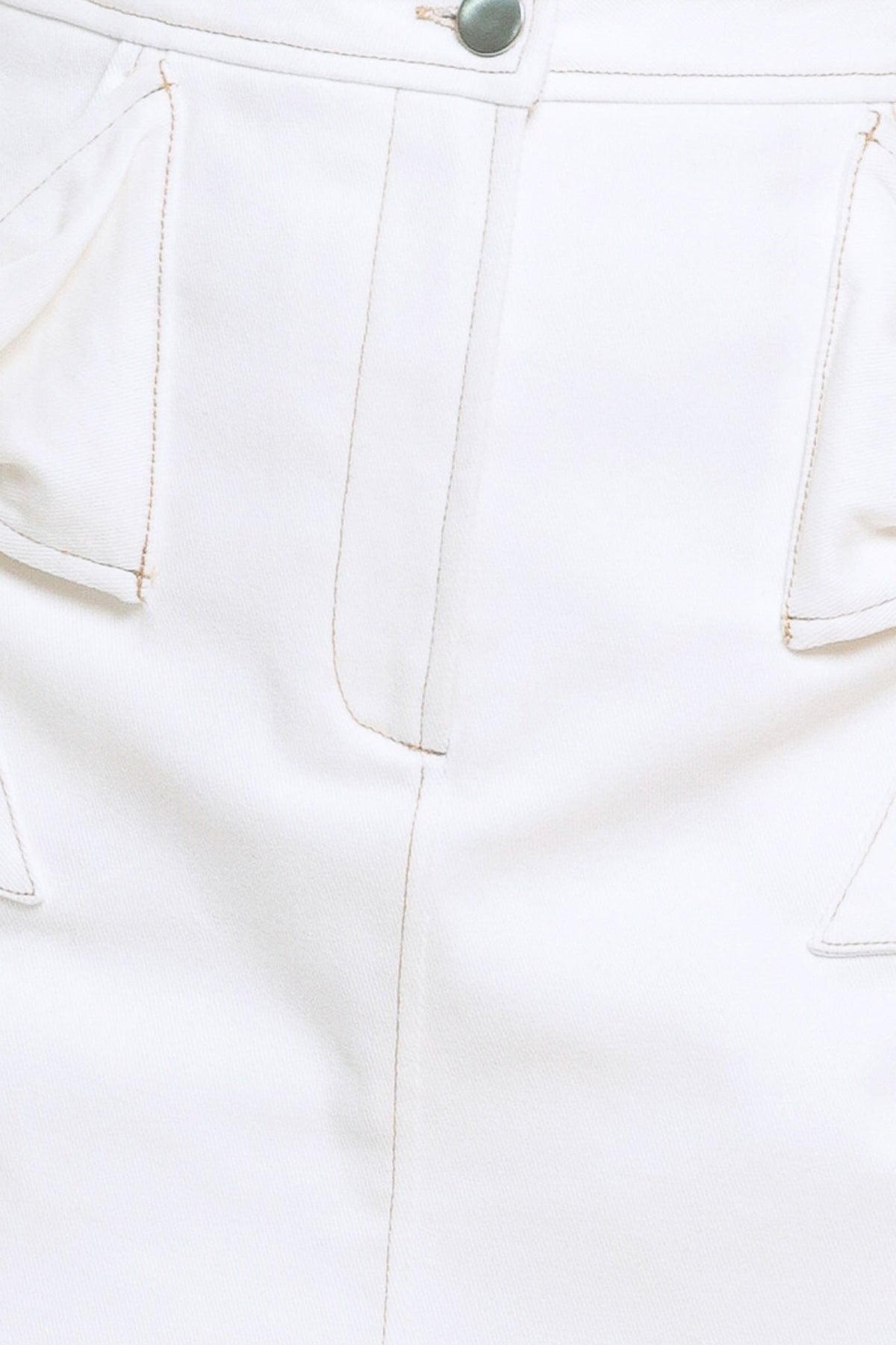 Close-up of a white pants pocket with a button on a light background