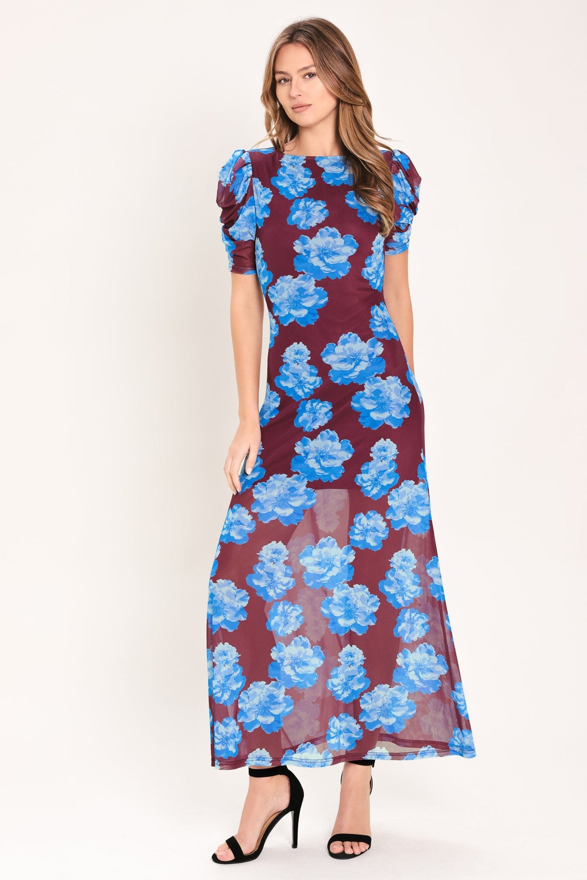 Woman wearing a floral dress with blue flowers on a white background