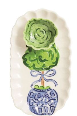 Decorative ceramic plate with a green topiary design on a white background