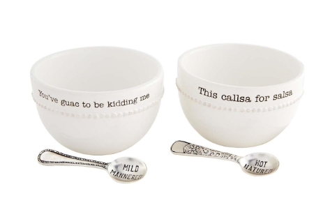 Two white ceramic bowls with text and two metal spoons on a white background