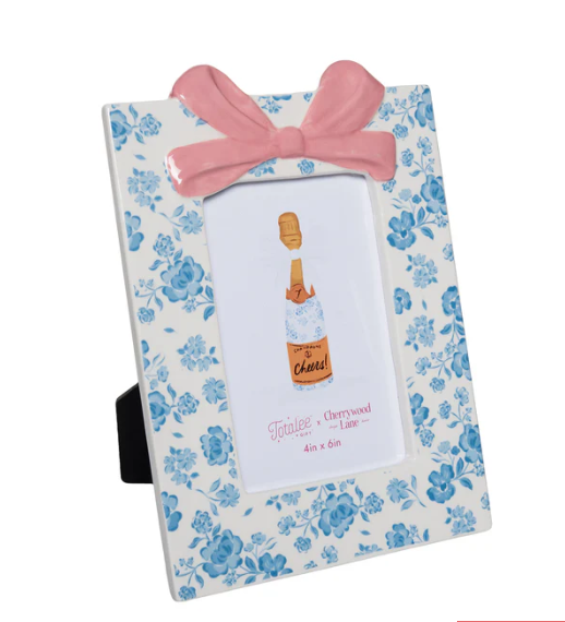 Floral photo frame with a pink bow on a white background