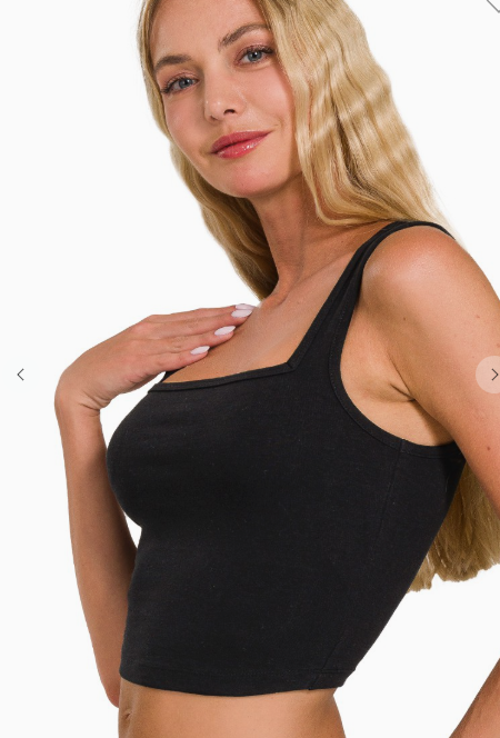 Woman wearing a black tank top on a white background