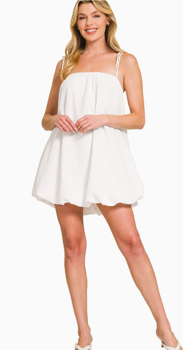 Woman wearing a white dress on a white background