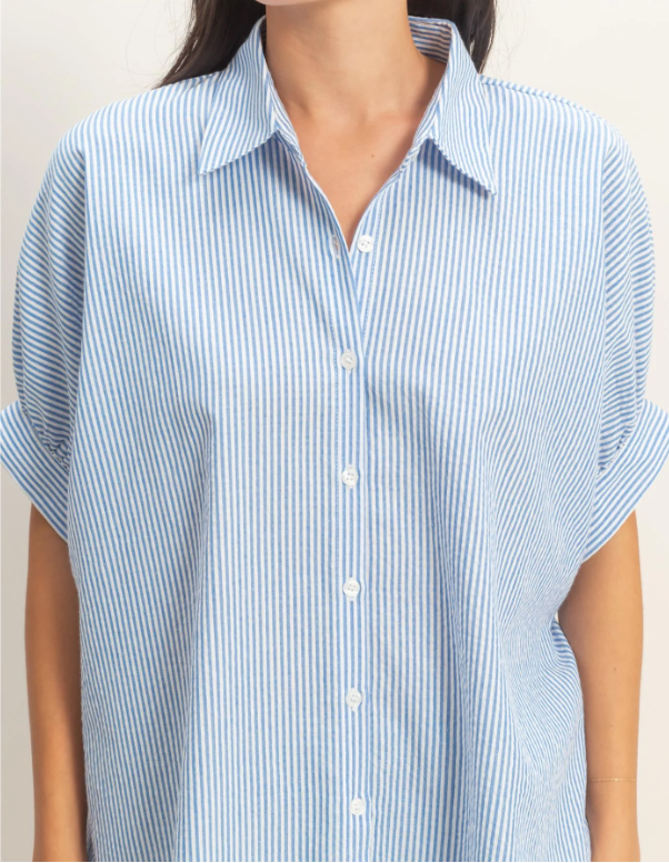 Close-up of a person wearing a blue and white striped shirt against a neutral background