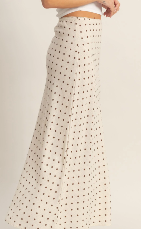 Beige polka dot skirt worn by a person on a plain background