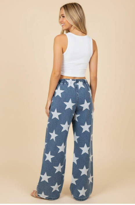 Woman wearing blue jeans with white star pattern on a beige background