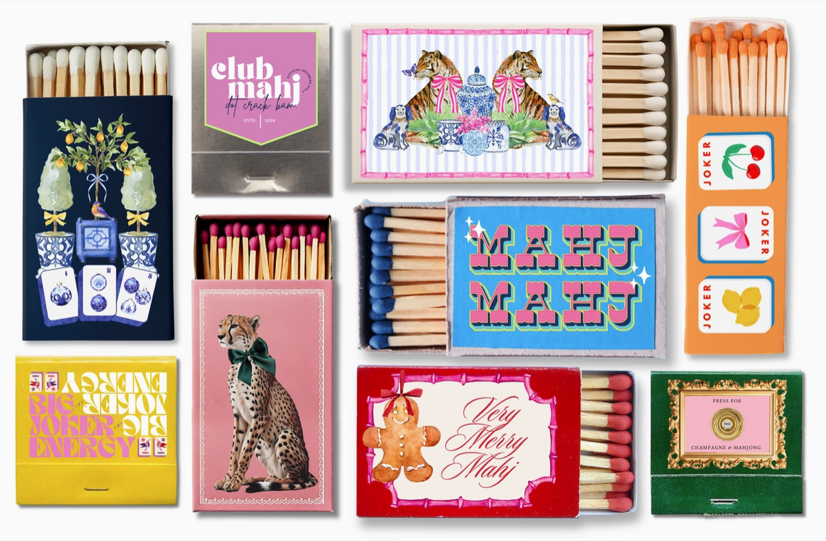A collage of ten different novelty matchboxes arranged in a 3x3 grid. Each matchbox features a unique design, including illustrations of tigers, a gingerbread man, a cheetah, playing cards, and retro text like 'club mahj' and 'Very Merry Mahj'.