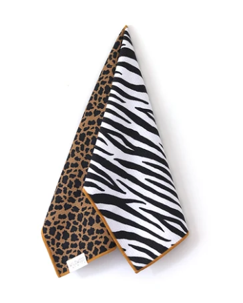 A folded fabric accessory, likely a scarf or pocket square, featuring a dual-pattern design. One side displays a classic black and white zebra print, while the other side shows a brown and black leopard print.