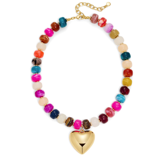 A colorful beaded necklace with marbled round beads in various vibrant colors, connected by a gold-tone chain and featuring a gold-tone heart-shaped pendant at the center, shown on a plain white background.