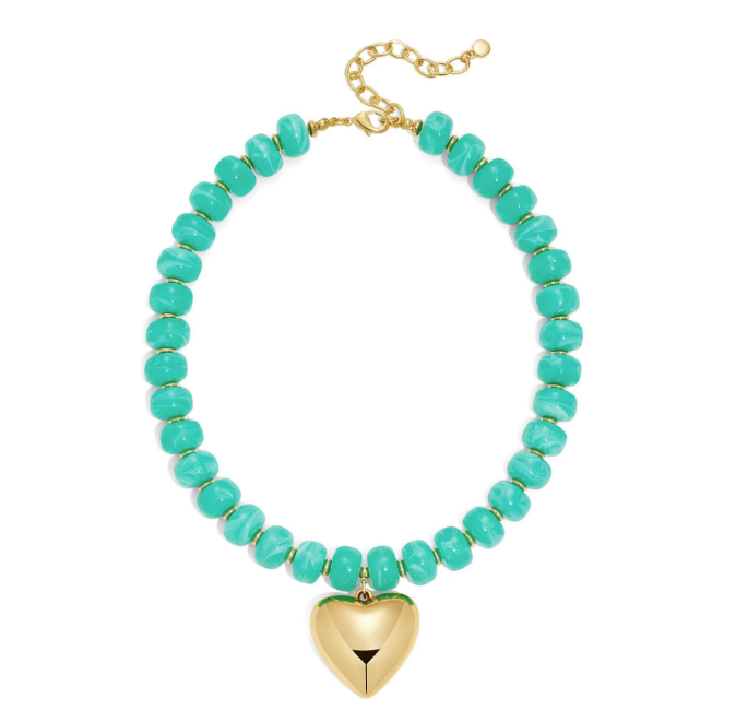 A turquoise and gold beaded necklace featuring a polished gold heart-shaped pendant, displayed on a clean white background.